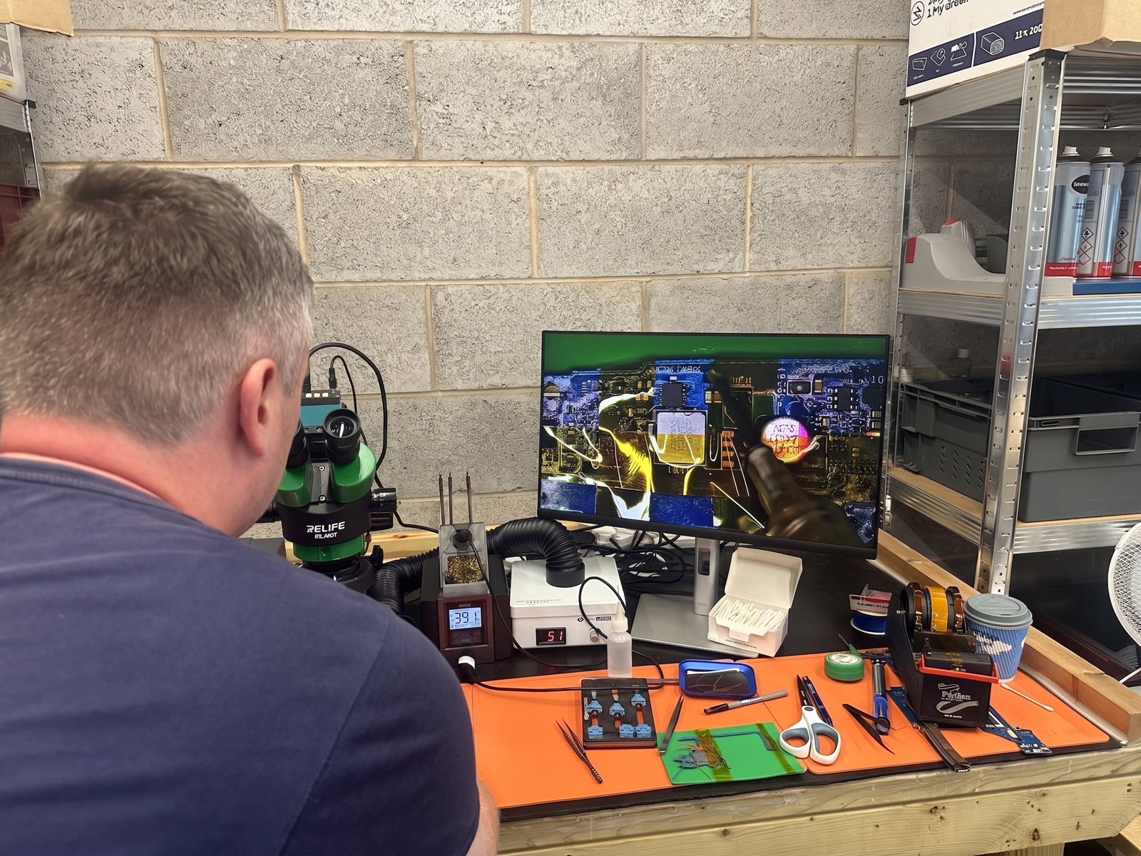 A student at the microscope during a real training course at FoneFunShop Sheffield